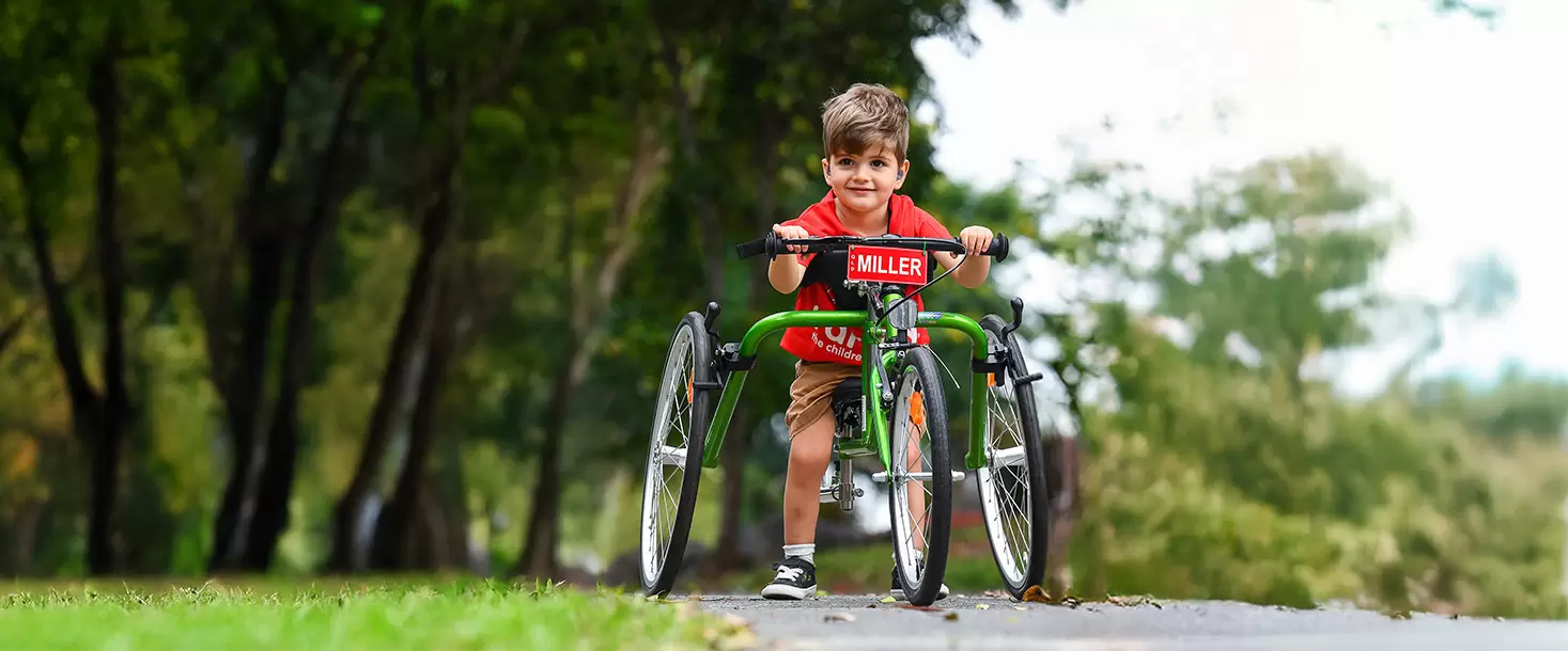 Miller Grant recipient riding 3 wheel accessible bike