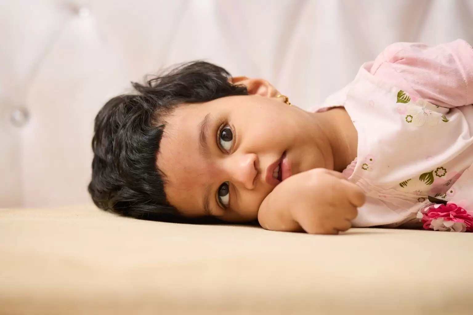 Grant recipient Huda laying on her side